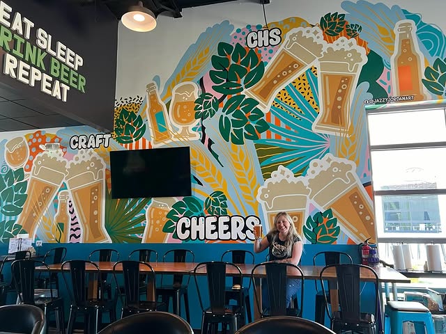 A colorful Cheers mural spanning an indoor wall